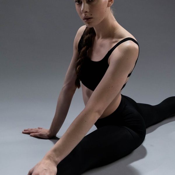 Person demonstrating balance and core strength in a minimalist setting.